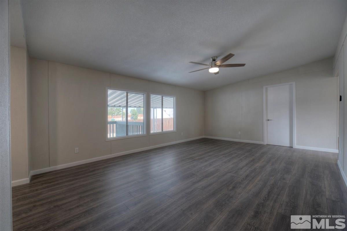 370 Scorpio Circle Reno, NV 89521 - Photo 5 of 25 an empty room with wooden floor and windows