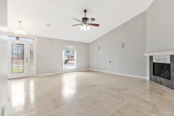 an empty room with windows and entrance