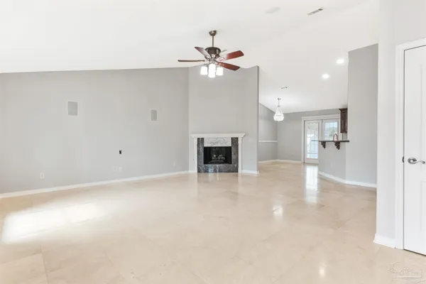 a kitchen with stainless steel appliances granite countertop a stove top oven a refrigerator a sink and a dining table with wooden floor