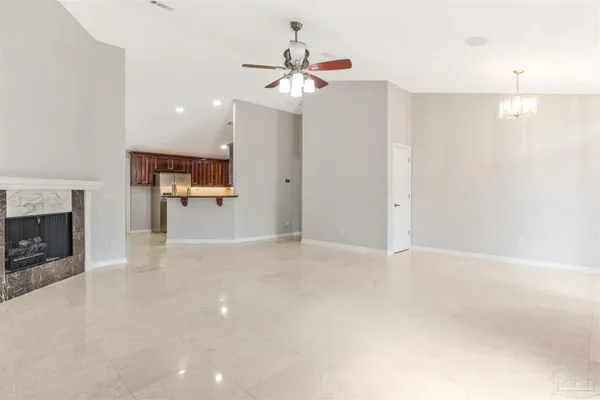 a kitchen with stainless steel appliances a stove top oven a sink and a refrigerator with wooden floor