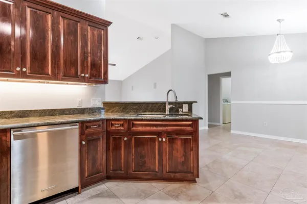 a kitchen with wooden cabinets and a stove top oven