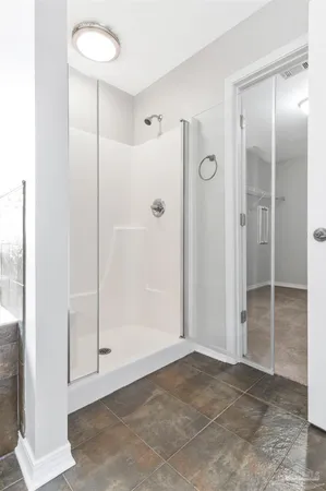 a bathroom with a granite countertop toilet sink and mirror