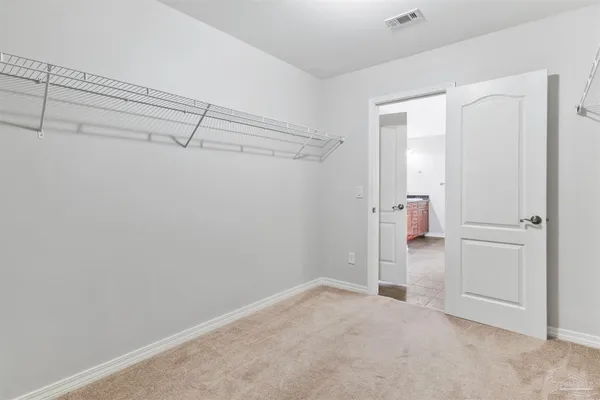 a bathroom with a granite countertop toilet sink and mirror