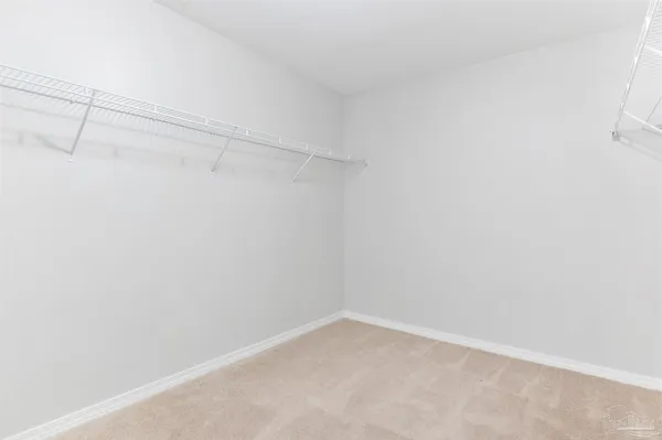 an empty room with a window and a ceiling fan