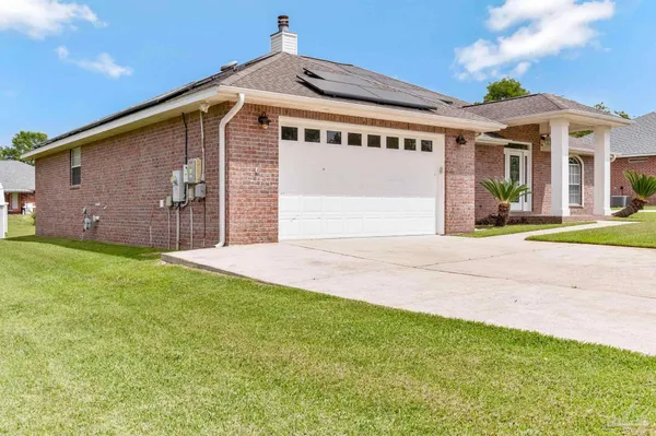 a front view of a house with a garden and yard