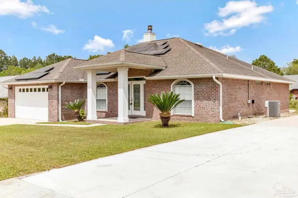 a front view of a house with a yard and potted plants