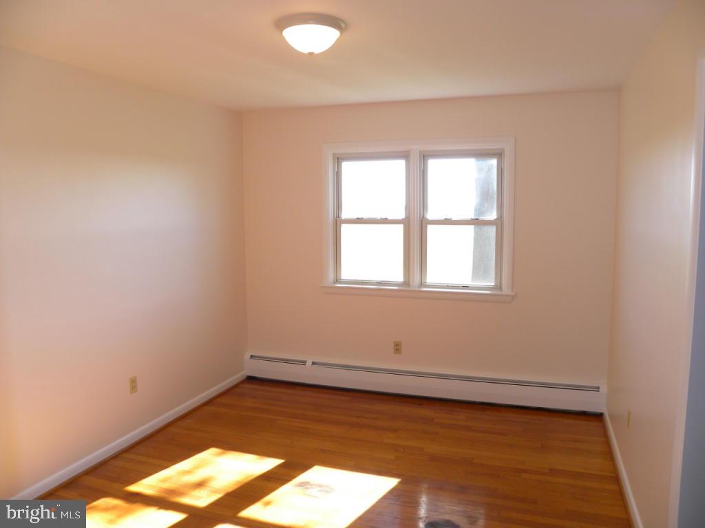 1524 Mountain Road Manheim, PA 17545 - Photo 14 of 17 an empty room with wooden floor and windows