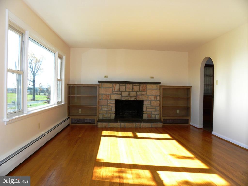 1524 Mountain Road Manheim, PA 17545 - Photo 7 of 17 a view of an empty room with a fireplace and a window