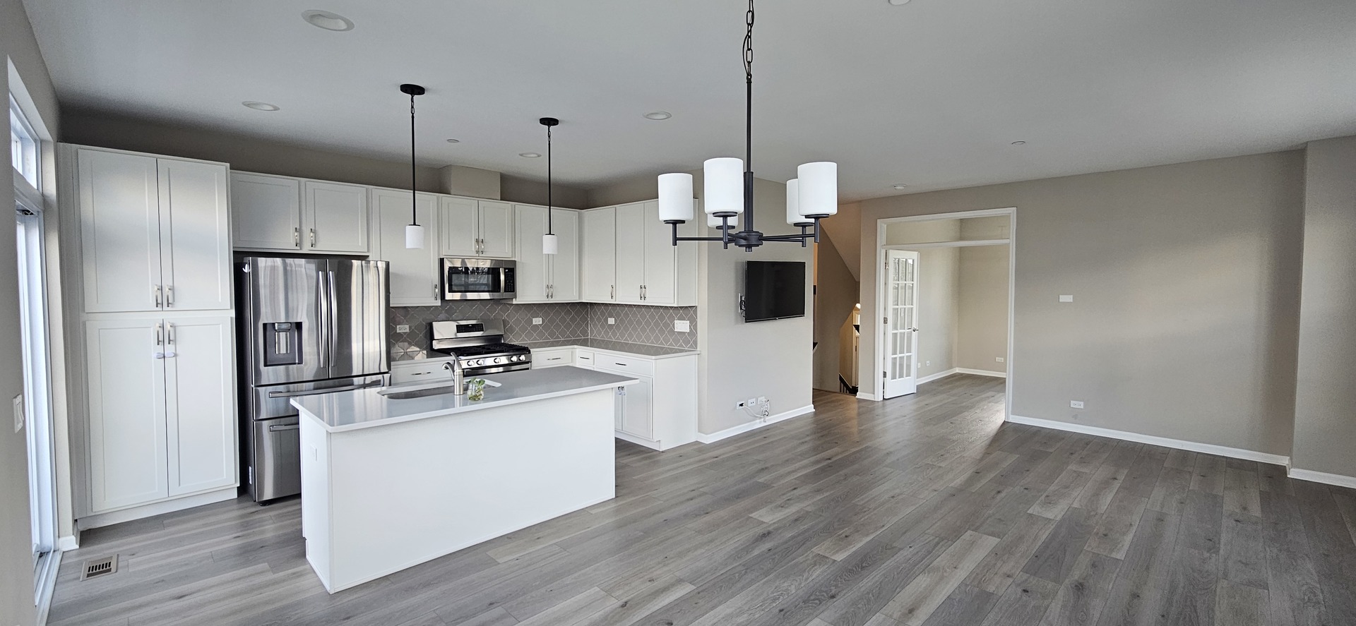 210 Timberleaf Circle Roselle, IL 60172 - Photo 2 of 14 a kitchen with stainless steel appliances kitchen island granite countertop a refrigerator a stove and white cabinets with wooden floor