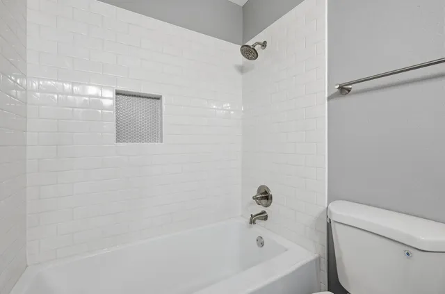 a bathroom with a bathtub and a toilet