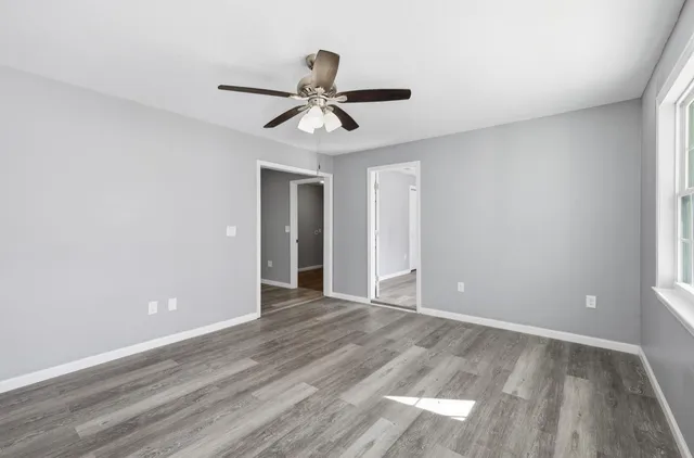a view of an empty room and wooden floor