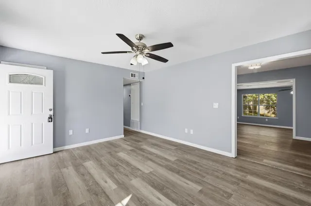wooden floor in an empty room with a window