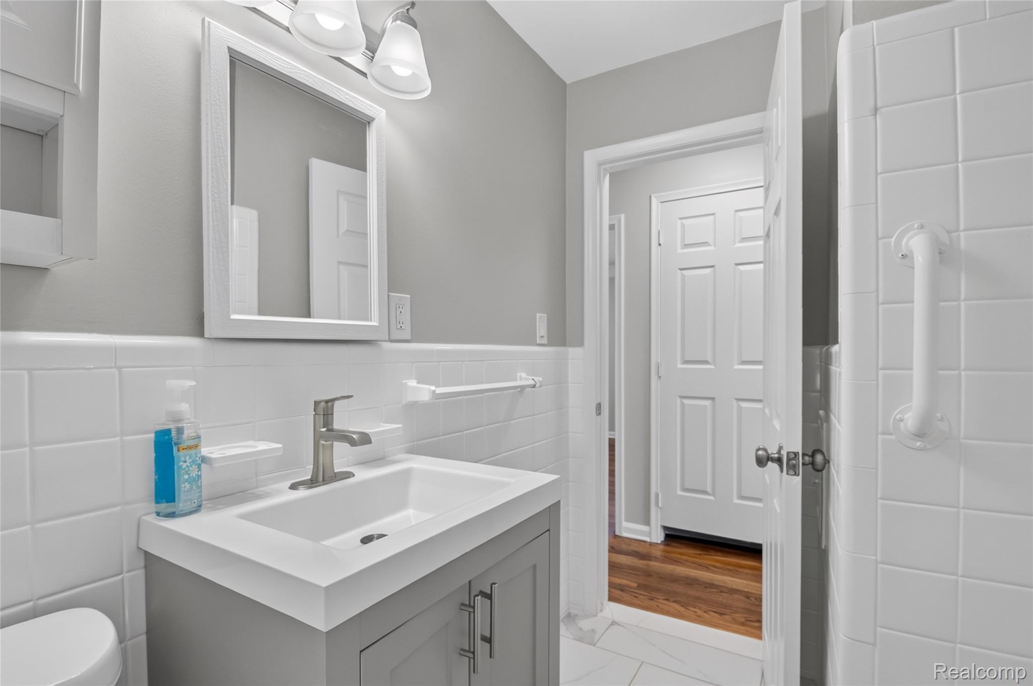 12972 Callender Street Southgate, MI 48195 - Photo 20 of 40 Bathroom vanity featuring a single basin, brushed nickel faucet, and a framed mirror