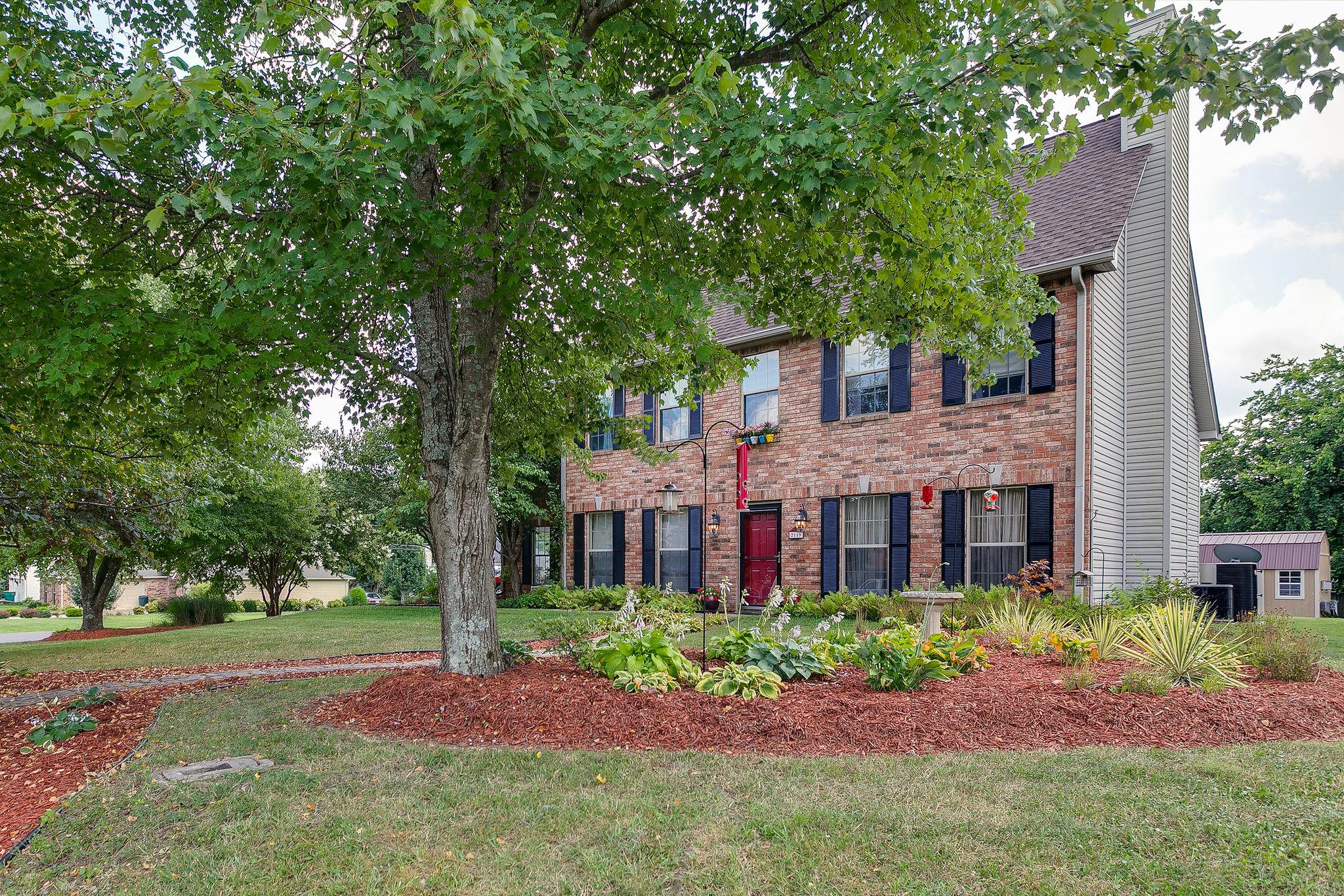 2119 Spring Hill Circle Spring Hill, TN 37174 - Photo 3 of 28 a front view of a house with a garden