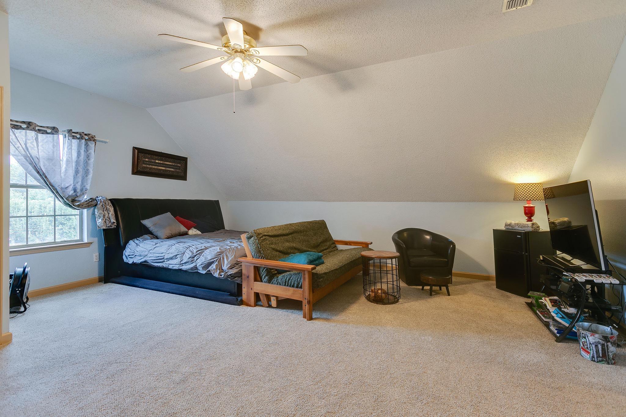 2119 Spring Hill Circle Spring Hill, TN 37174 - Photo 22 of 28 a bedroom with furniture and a flat screen tv