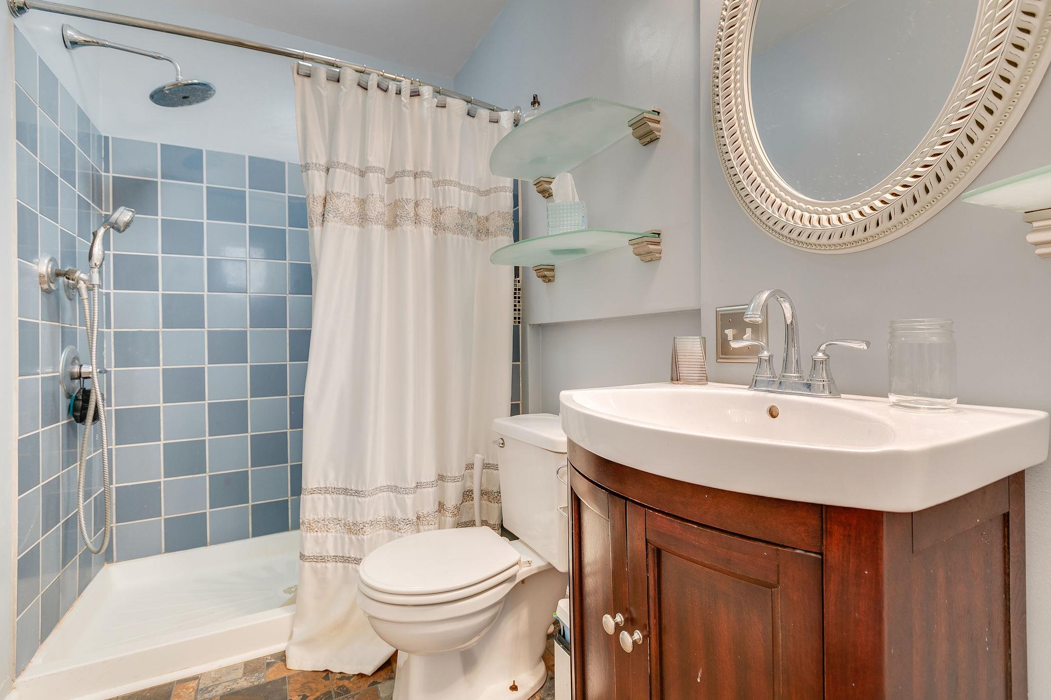 2119 Spring Hill Circle Spring Hill, TN 37174 - Photo 23 of 28 a bathroom with a sink a toilet a mirror and shower