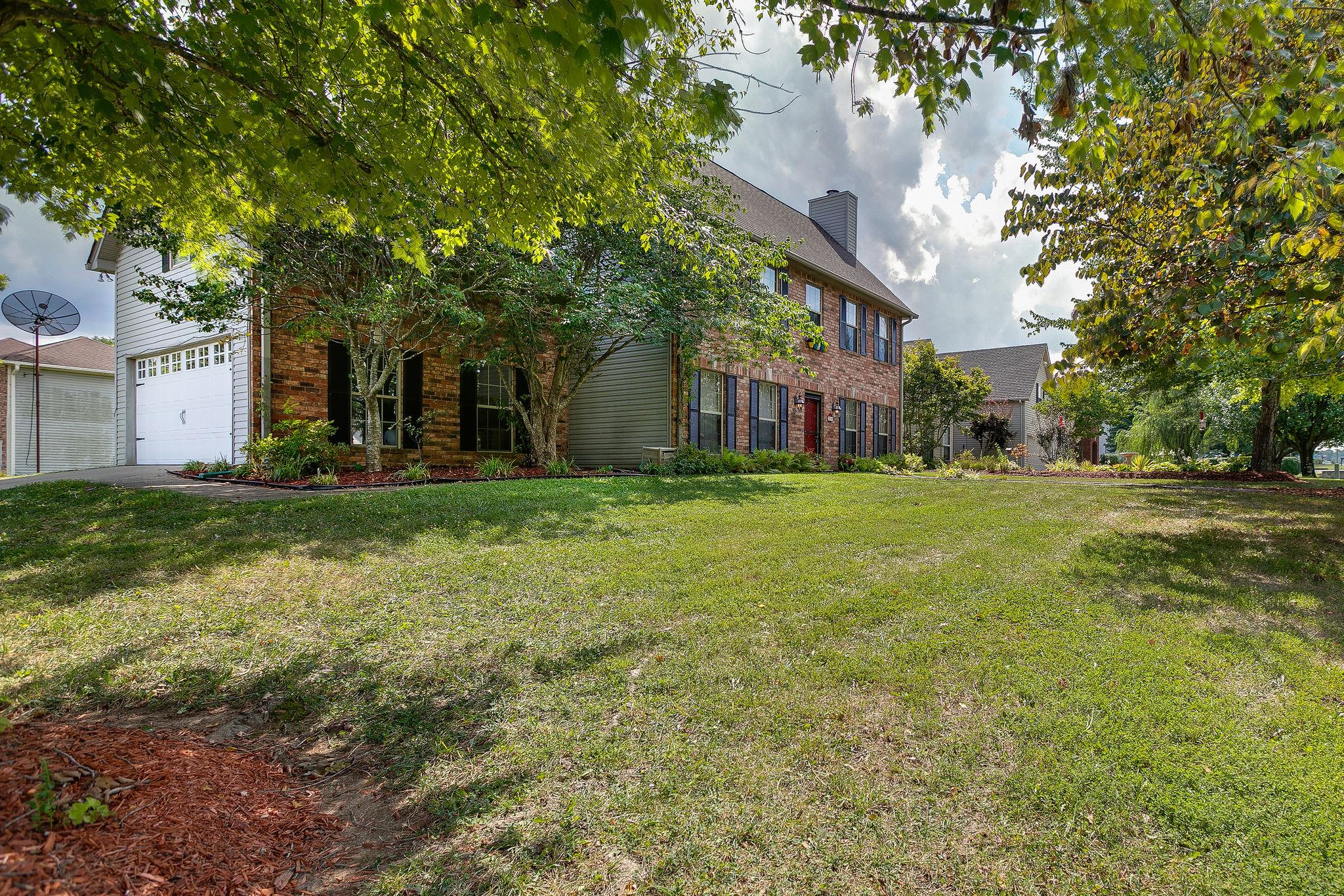 2119 Spring Hill Circle Spring Hill, TN 37174 - Photo 4 of 28 a view of a house with a big yard and large trees