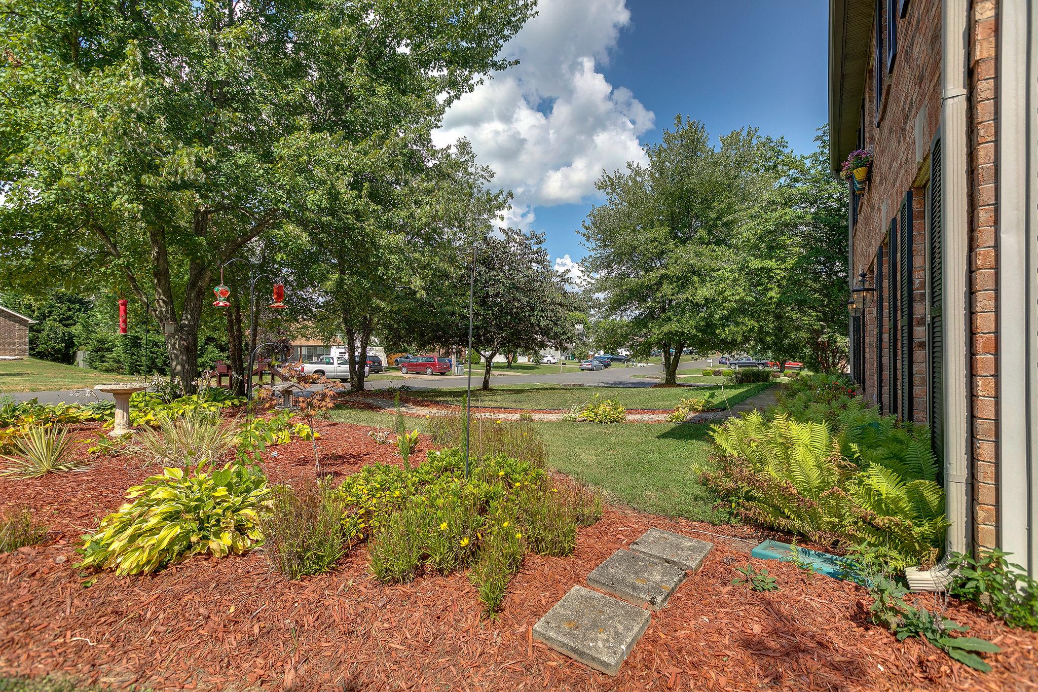 2119 Spring Hill Circle Spring Hill, TN 37174 - Photo 5 of 28 a view of a garden with a bench