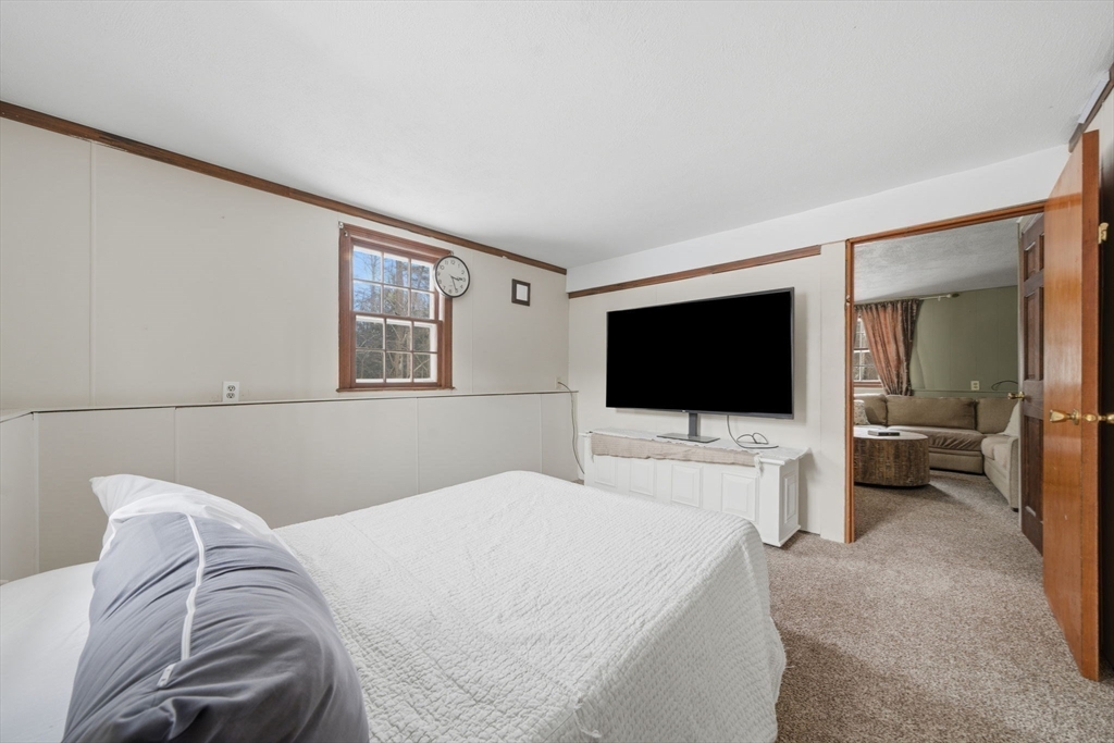 14 Seabrook Road Salisbury, MA 01952 - Photo 16 of 30 a bedroom with a bed and a flat screen tv