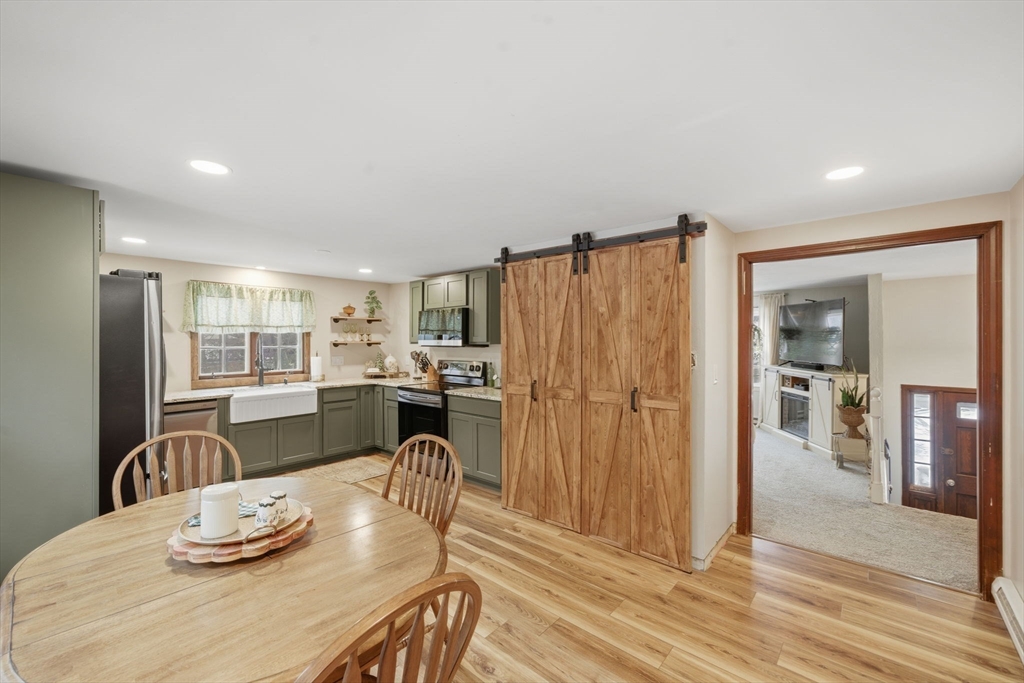 14 Seabrook Road Salisbury, MA 01952 - Photo 7 of 30 a kitchen with granite countertop kitchen island stainless steel appliances a refrigerator a sink a dining table and chairs
