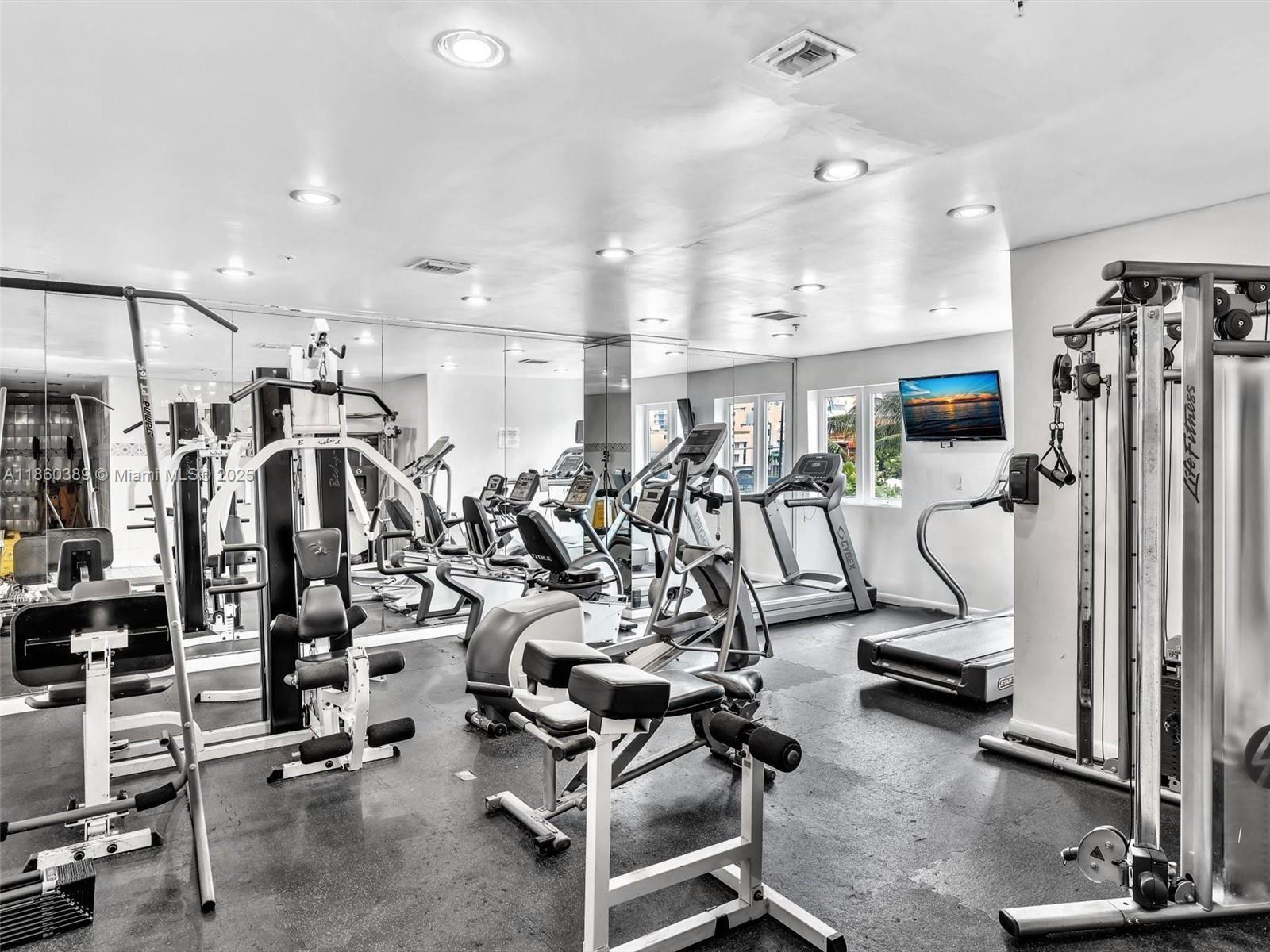 4101 Pine Tree Drive, Unit 926 925 Miami Beach, FL 33140 - Photo 4 of 12 a view of a room with gym equipment