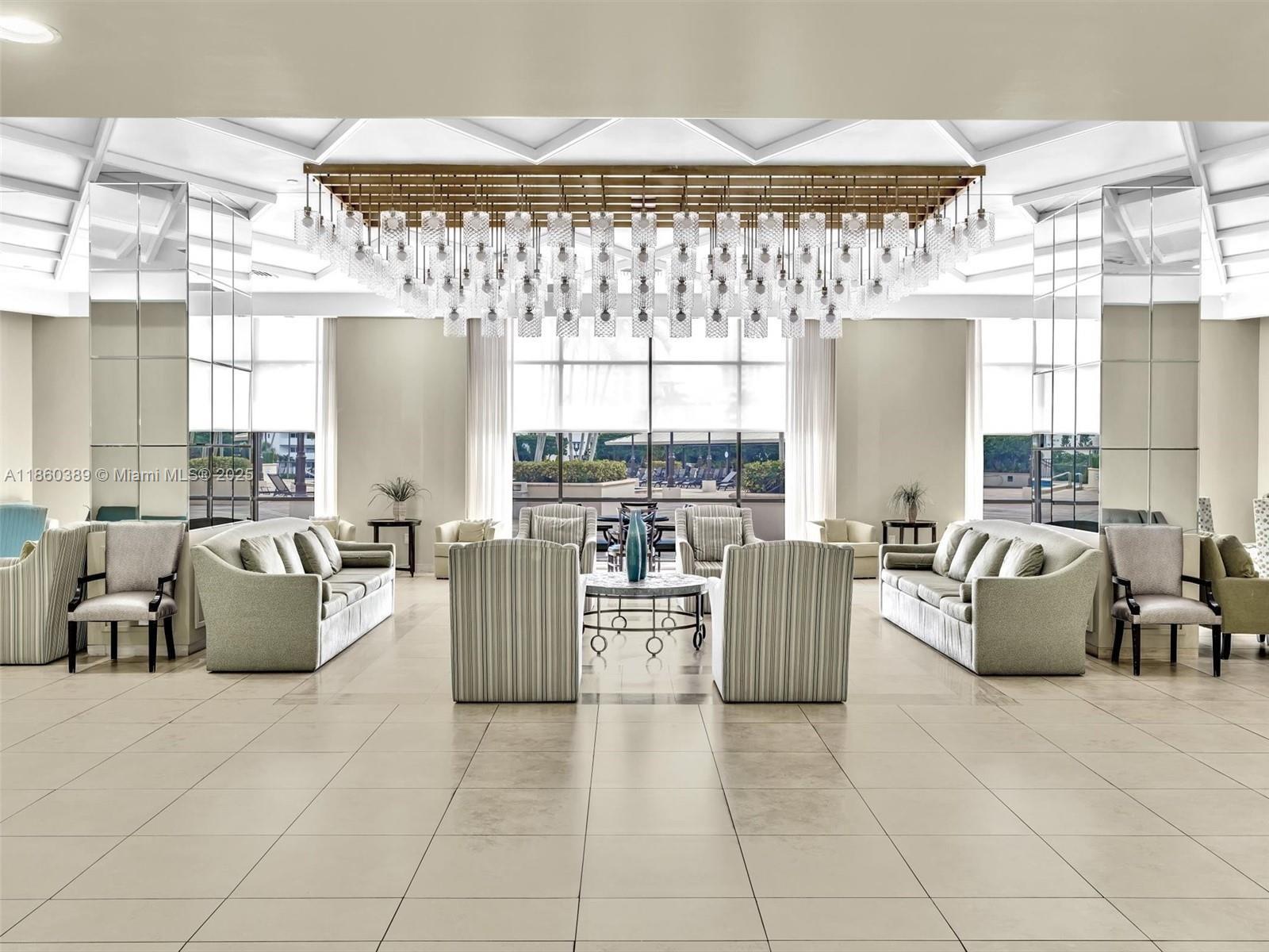 4101 Pine Tree Drive, Unit 926 925 Miami Beach, FL 33140 - Photo 5 of 12 a living room with furniture and a large window