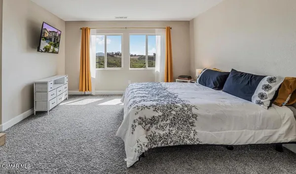 a bedroom with a bed and cabinets