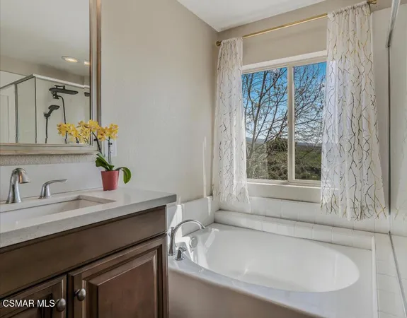 a large bed sitting in a bedroom next to a window