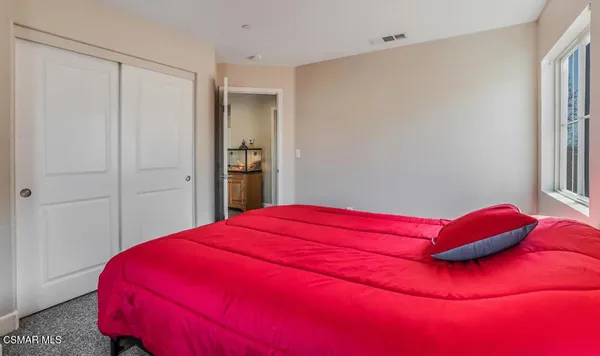 a bed room with a bed and a window