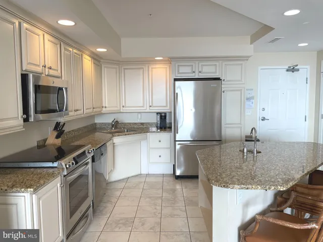 a kitchen with a sink stove and refrigerator