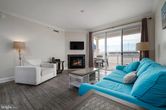 a living room with furniture fireplace and a large window