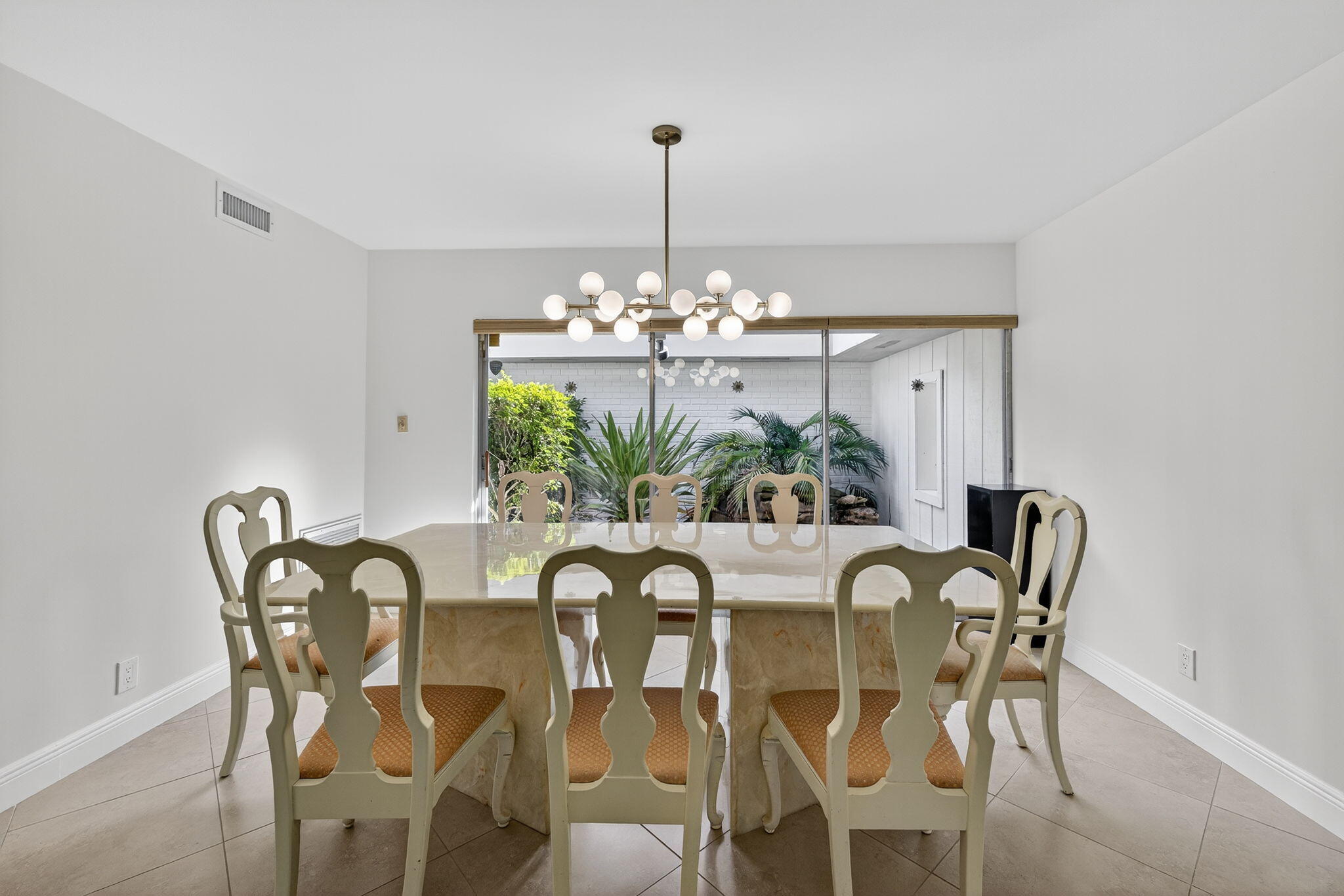5503 Bluejack Oak Circle Tamarac, FL 33319 - Photo 12 of 35 a view of a dining room with furniture a chandelier and wooden floor
