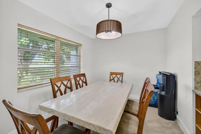 a view of a dining room with furniture wooden floor and chandelier
