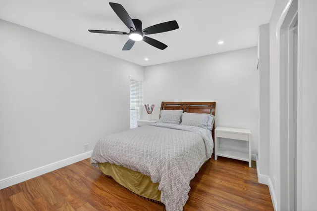 a bedroom with a bed and a ceiling fan