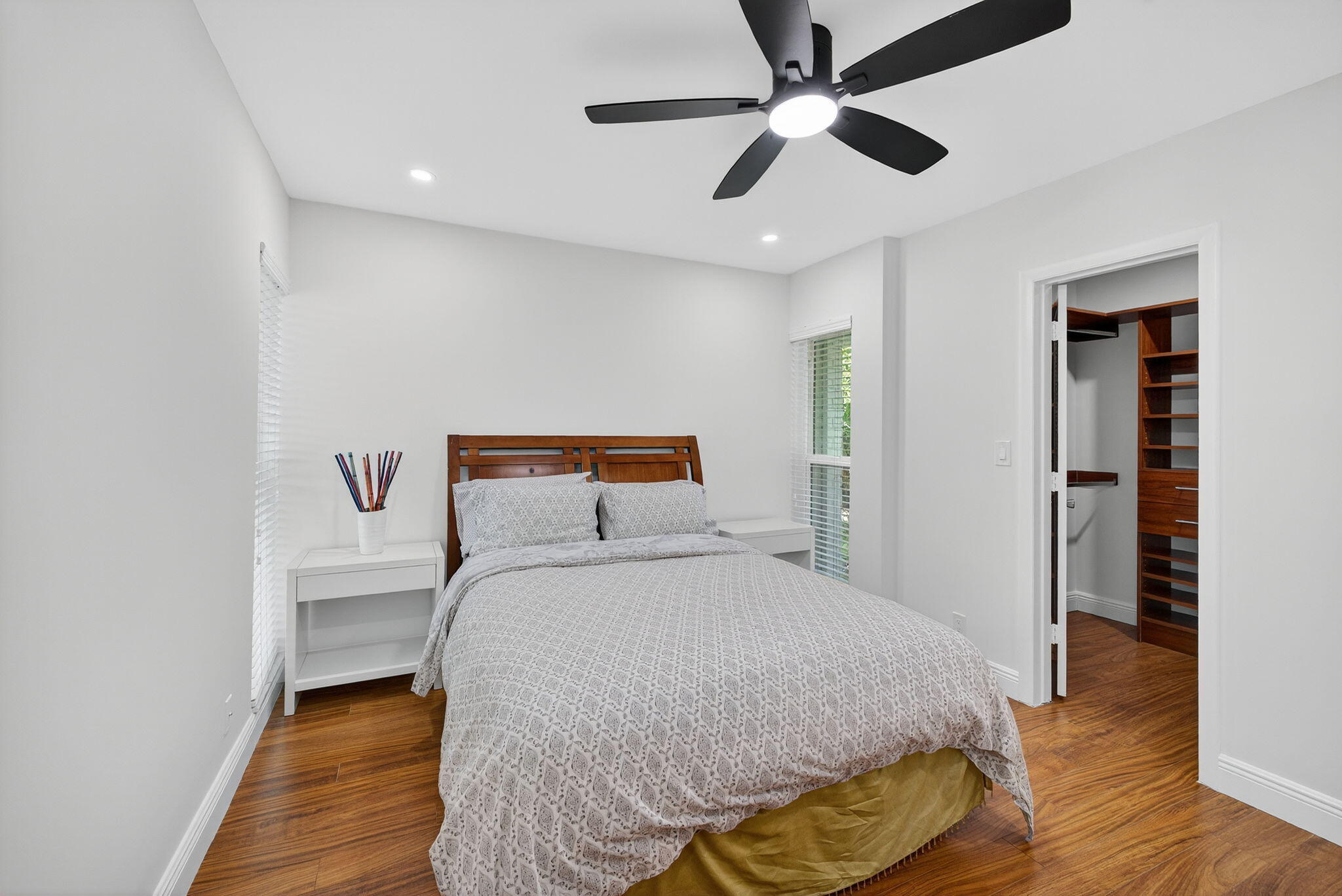 5503 Bluejack Oak Circle Tamarac, FL 33319 - Photo 25 of 35 a bedroom with a bed and a chandelier