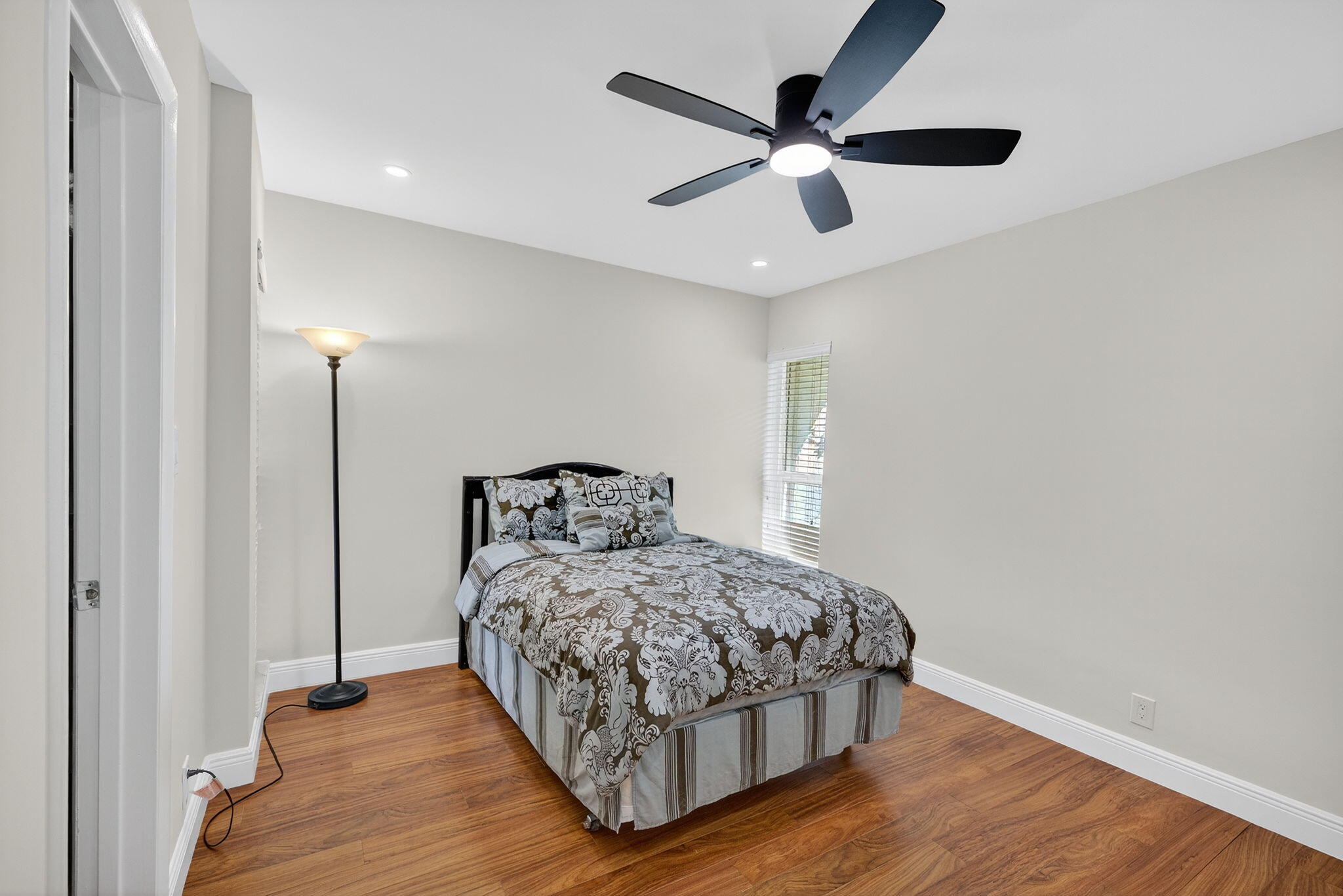5503 Bluejack Oak Circle Tamarac, FL 33319 - Photo 27 of 35 a bedroom with a bed and a ceiling fan