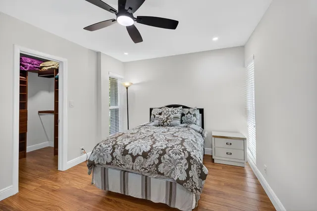 a bedroom with a bed and a chandelier