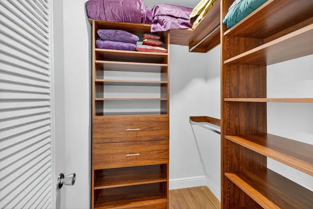 a view of walk in closet with empty racks