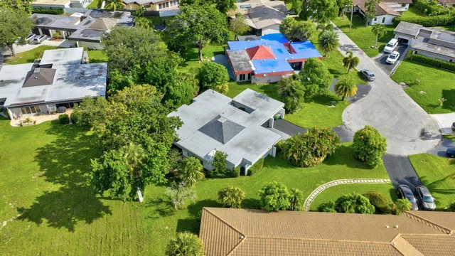 an aerial view of a house with a garden and yard