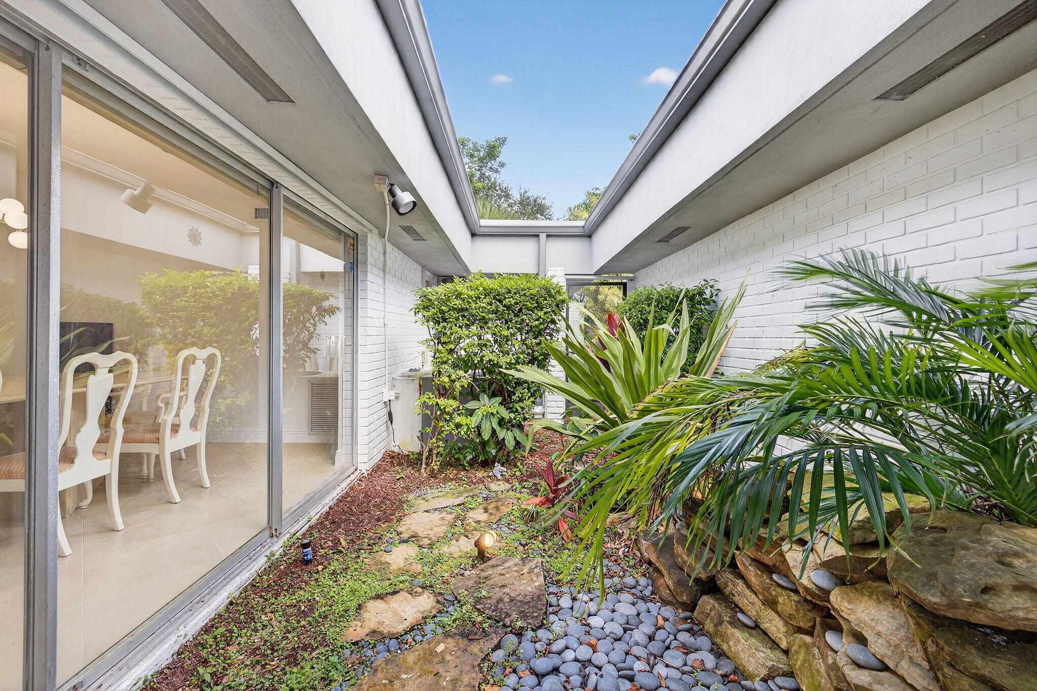 5503 Bluejack Oak Circle Tamarac, FL 33319 - Photo 7 of 35 a view of a porch with chairs and potted plant
