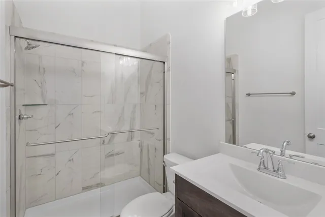 a bathroom with a sink toilet and shower