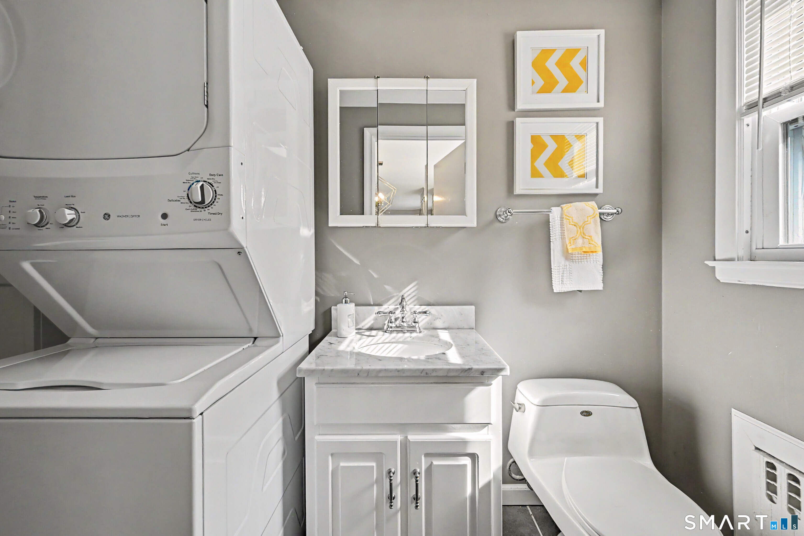 524 Ferry Road Orange, CT 06477 - Photo 22 of 40 a bathroom with a toilet sink and mirror