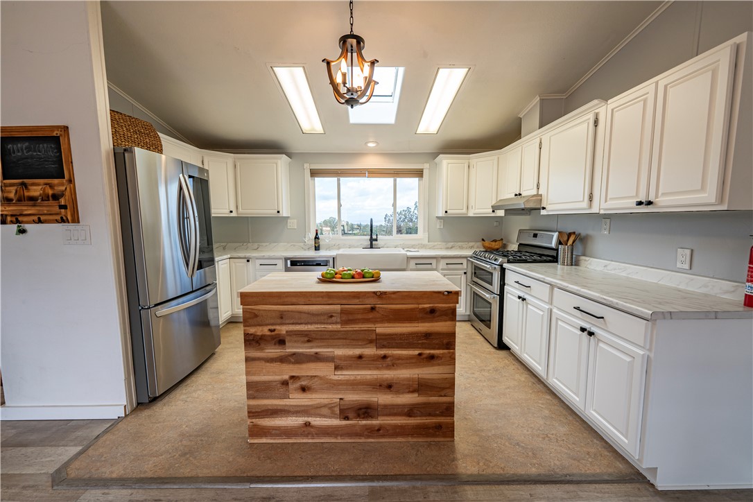 2765 North Silver Springs Road Kingman, AZ 86401 - Photo 39 of 60 a kitchen with a refrigerator sink and cabinets