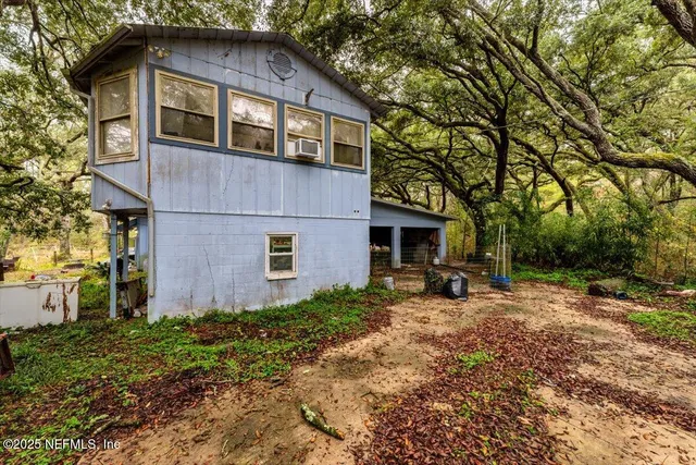 a front view of a house with yard and trees