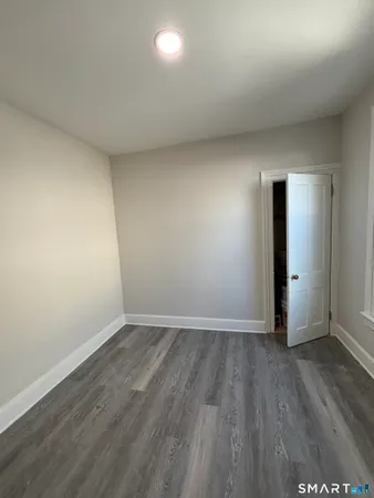 a view of an empty room and wooden floor