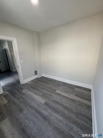 a view of an empty room and wooden floor