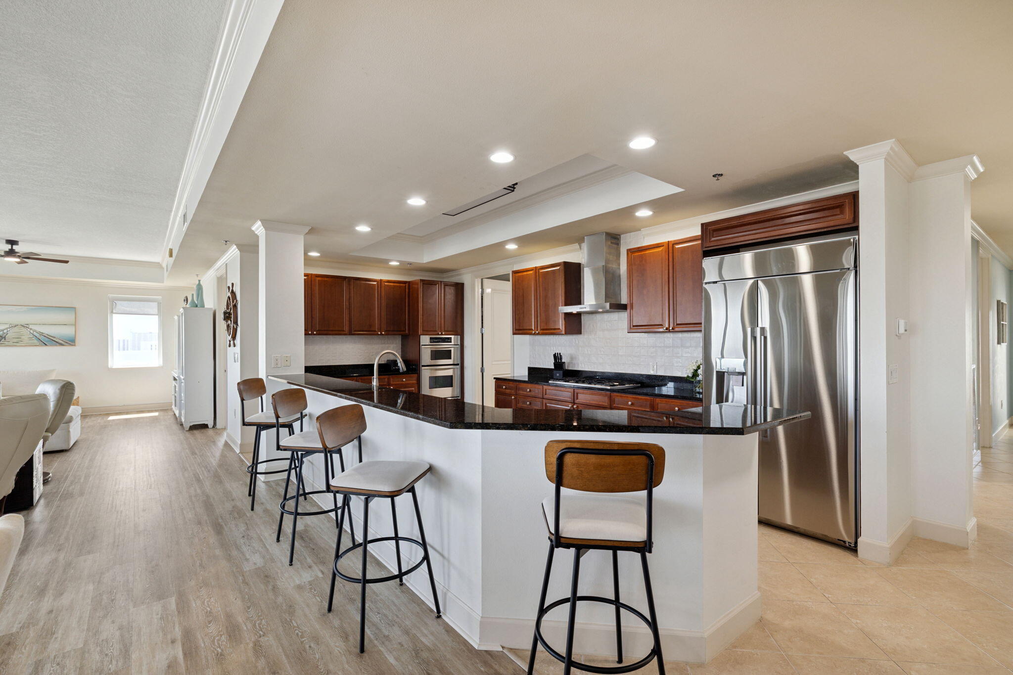 725 Gulf Shore Drive, Unit 902A Destin, FL 32541 - Photo 14 of 102 a kitchen with stainless steel appliances granite countertop a refrigerator a stove a sink a dining table and chairs with wooden floor