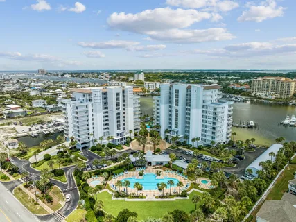 a view of a dining room and livingroom with furniture wooden floor a chandelier