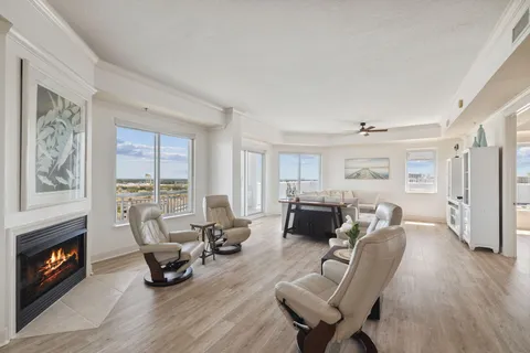 a dining room with furniture and a floor to ceiling window