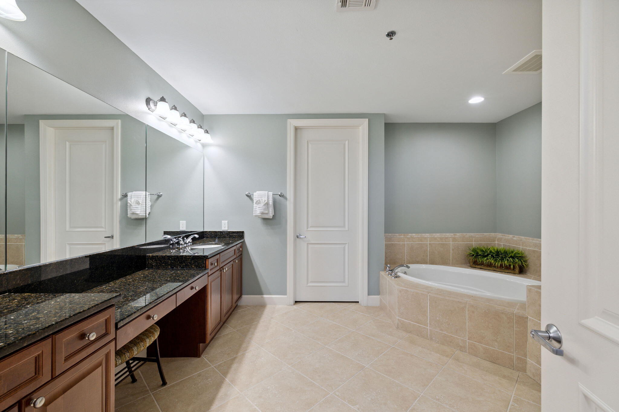 725 Gulf Shore Drive, Unit 902A Destin, FL 32541 - Photo 59 of 102 a spacious bathroom with a granite countertop tub a sink and a large mirror